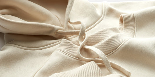 Close-up of a beige hoodie with drawstrings