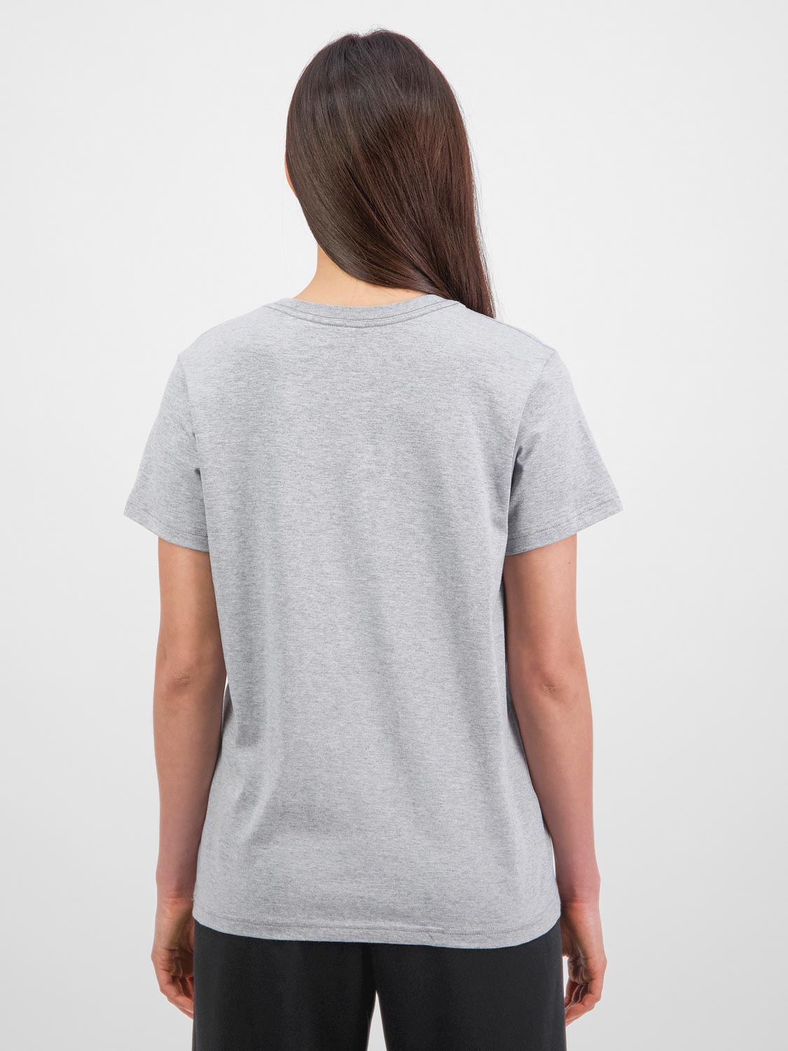 Back view of a woman wearing a grey short sleeve cotton t-shirt and black pants.