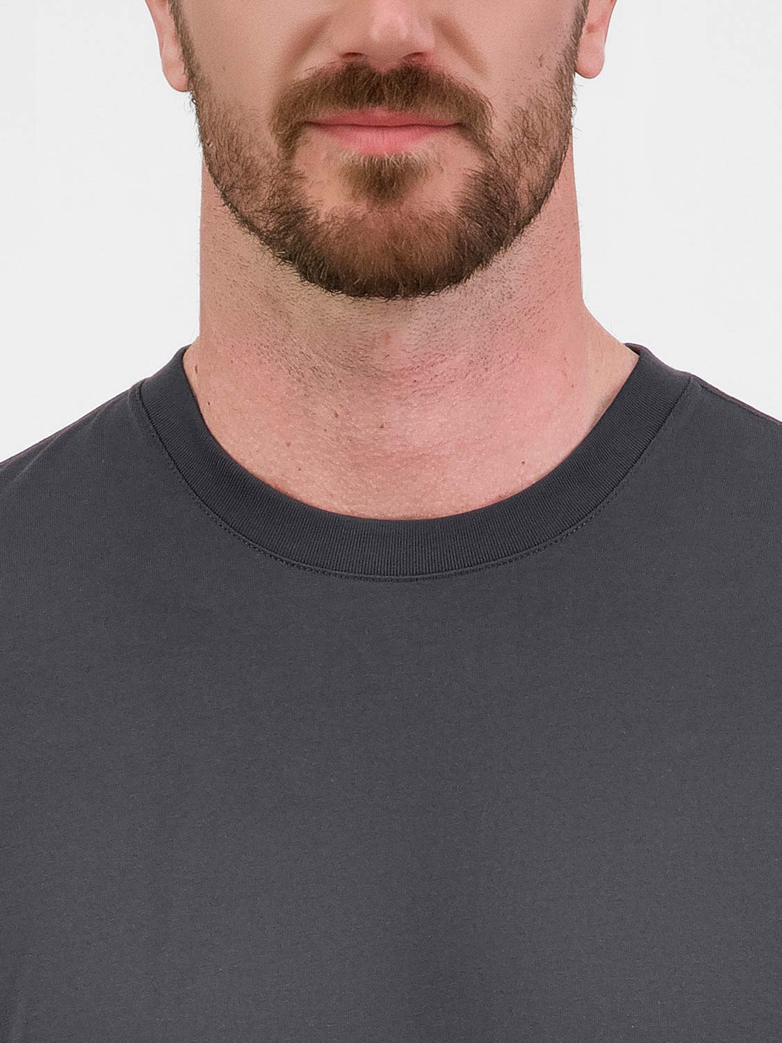 Close-up of a man wearing a charcoal grey short sleeve tee with a ribbed crew neckline.