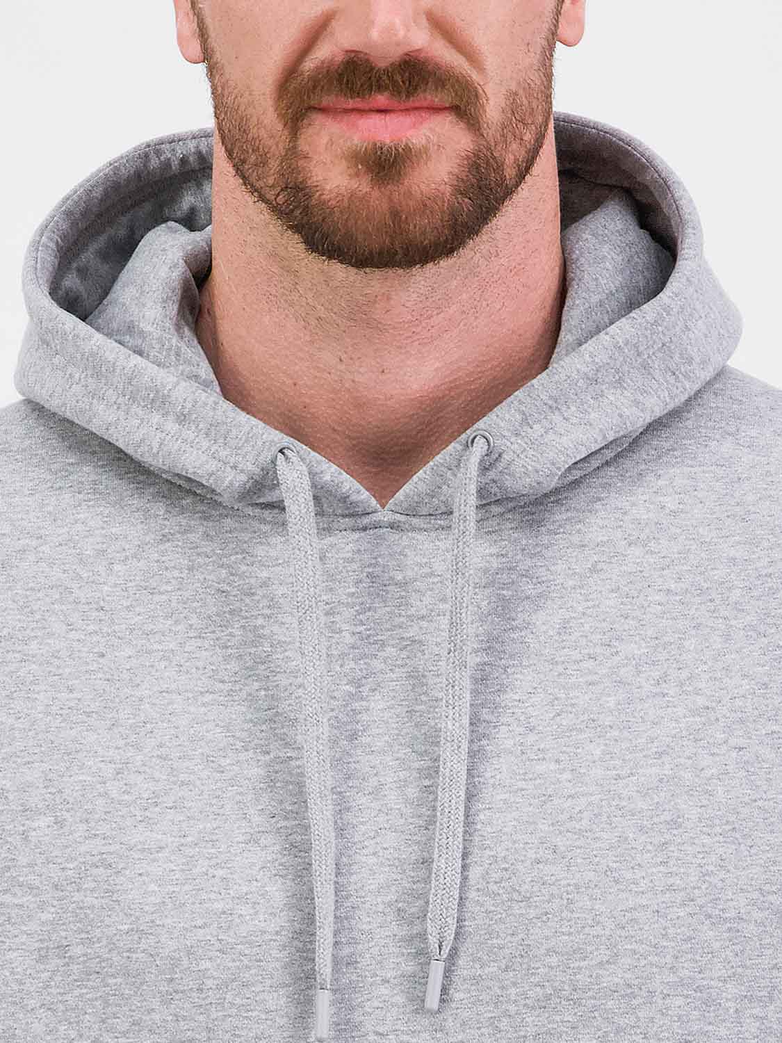 Close-up of a man wearing a grey heathered hoodie with a drawstring hood.