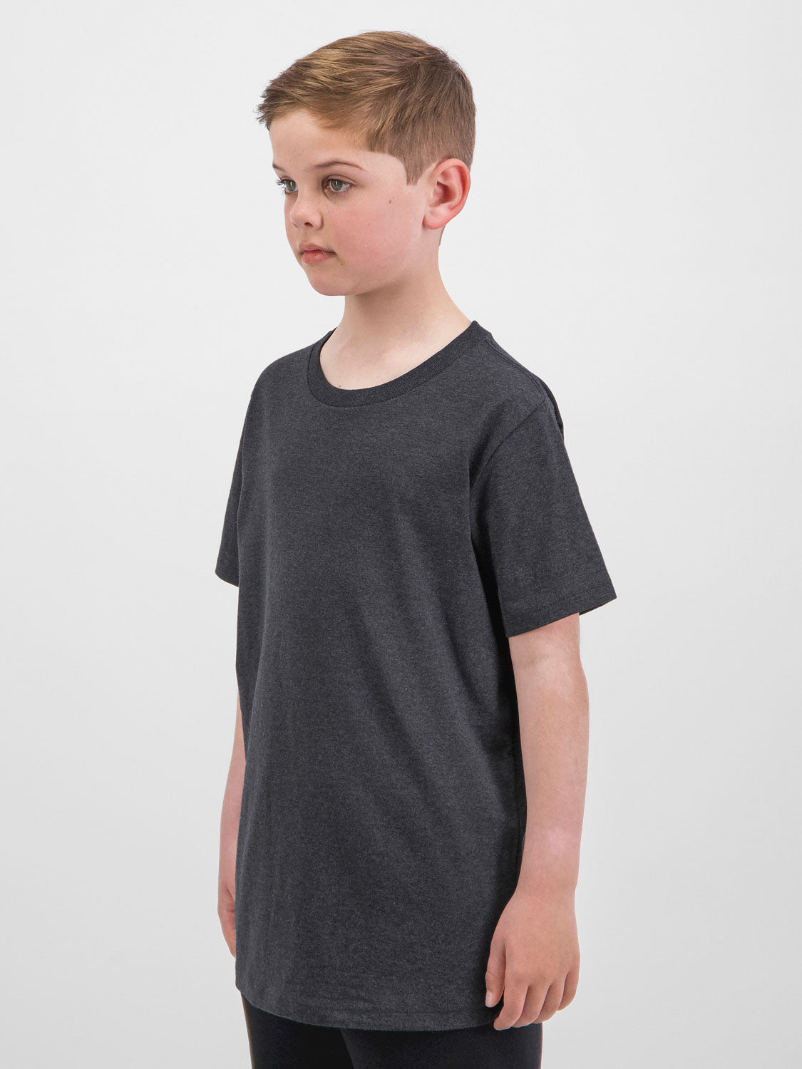 A young boy wearing a charcoal grey short sleeve cotton tee with a ribbed crew neckline.