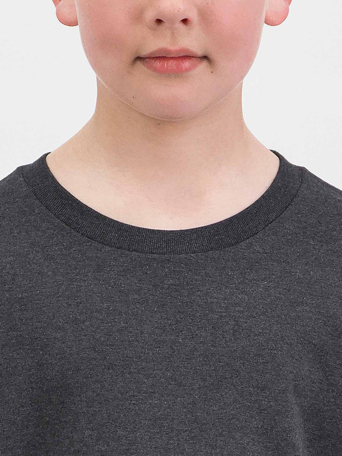 Close-up of a child wearing a dark charcoal grey cotton t-shirt with a ribbed crew neckline.