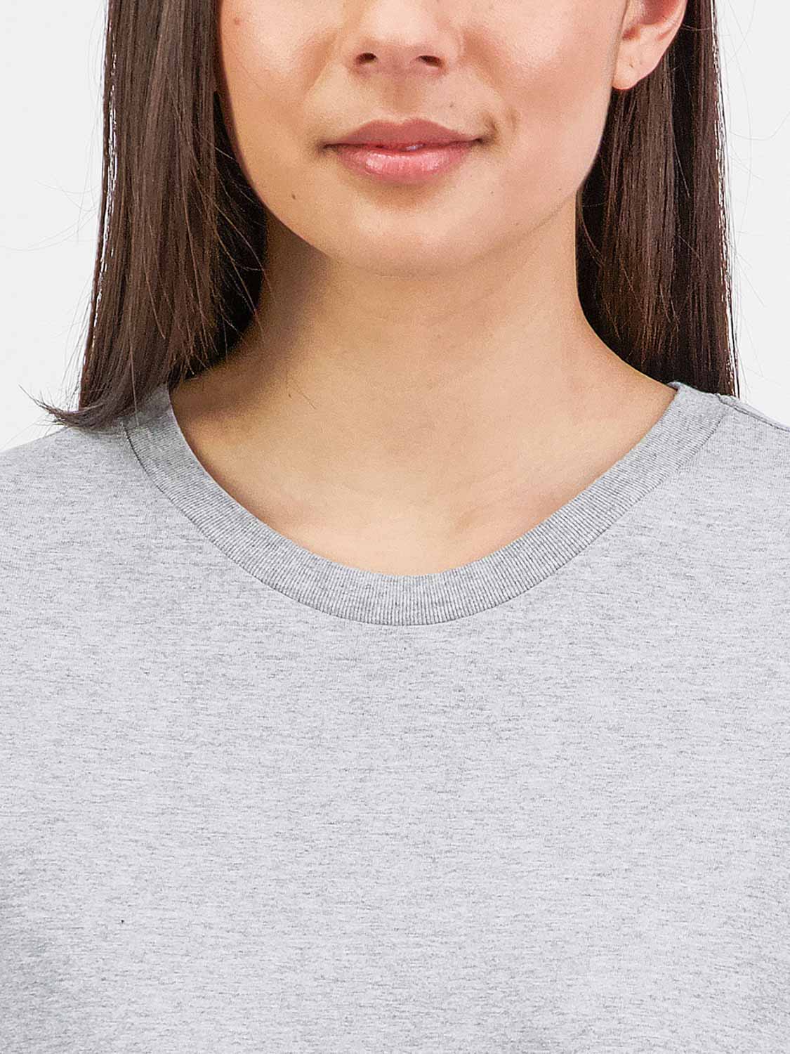 Close-up of a woman wearing a grey short sleeve tee with a ribbed crew neckline.