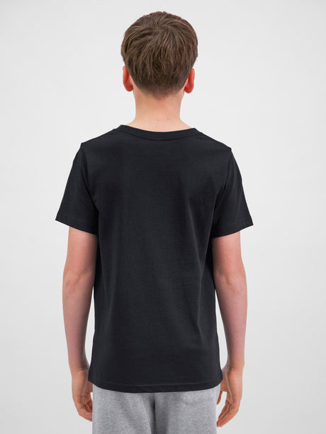 Rear view of a youth wearing a black short sleeve cotton t-shirt and grey shorts.