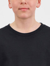 Close-up of a youth wearing a black short sleeve tee with a ribbed crew neckline.