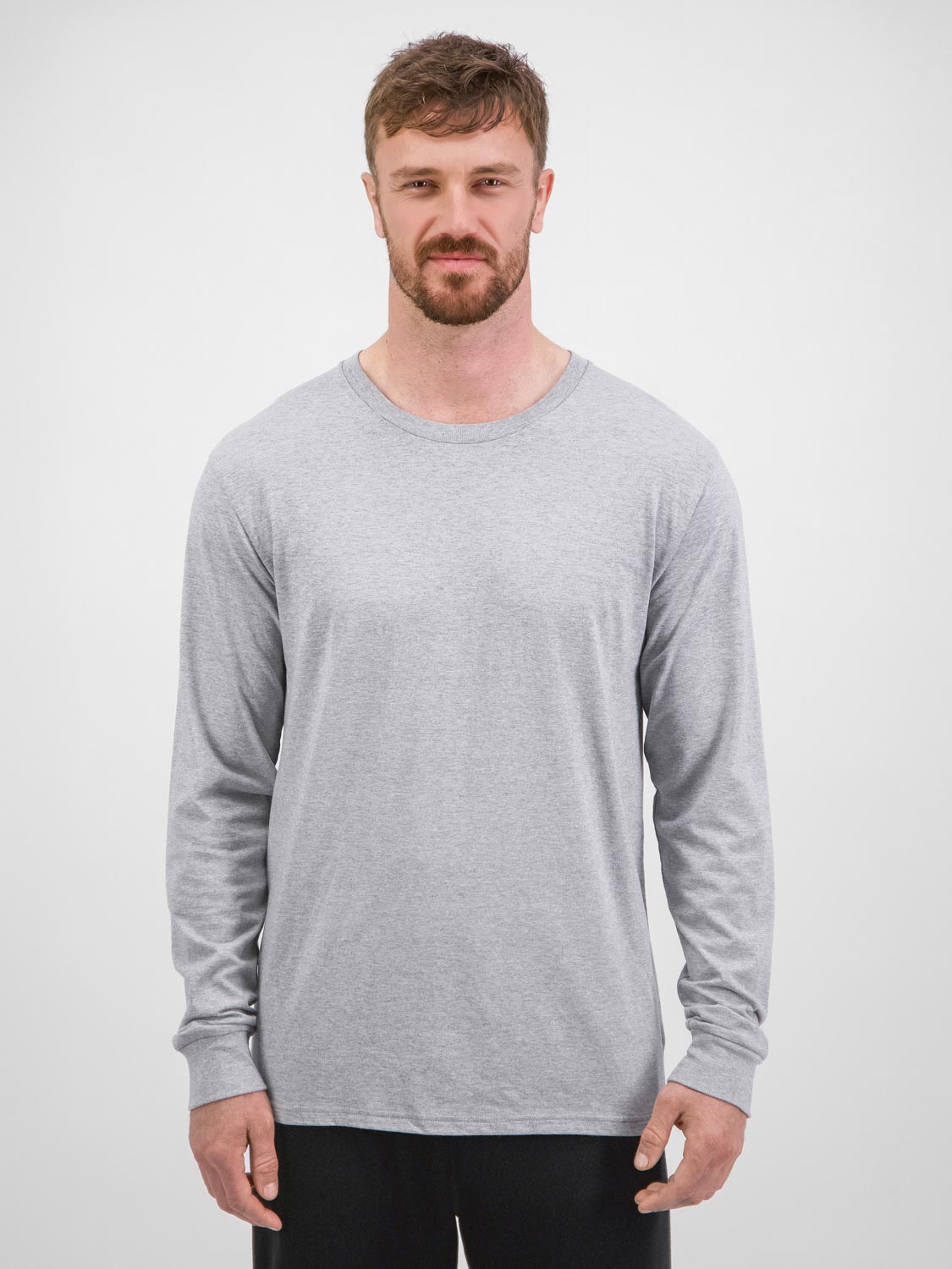 A man wearing a grey long-sleeve cotton crew neck t-shirt against a white background.