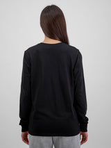 Rear view of a woman wearing a black long sleeve cotton t-shirt with ribbed cuffs.