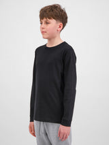 Youth Basis Long Sleeve Tee in black worn by a young boy against a white background.