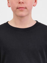 Close-up of a youth wearing a black long sleeve tee with a ribbed crew neckline.