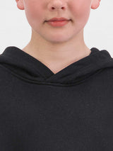 Close-up of a child wearing a black hooded sweatshirt with a crossover neckline.