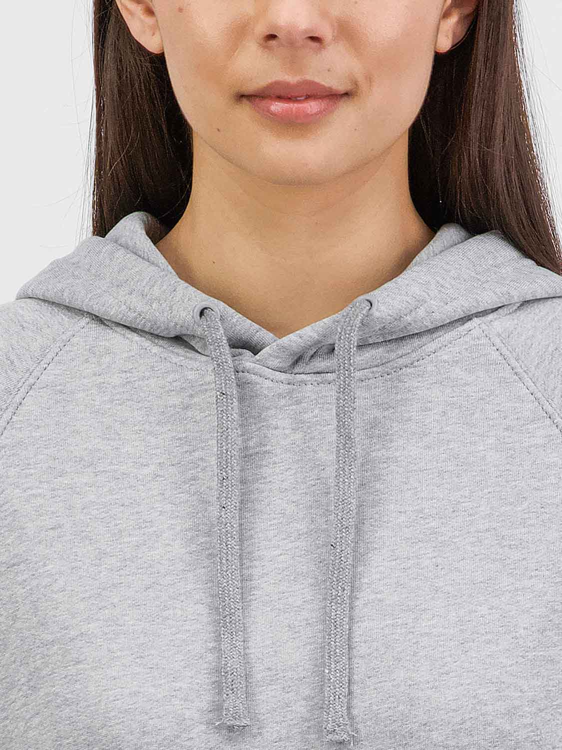 Close-up of a woman wearing a light grey marle hoodie with adjustable drawcords.