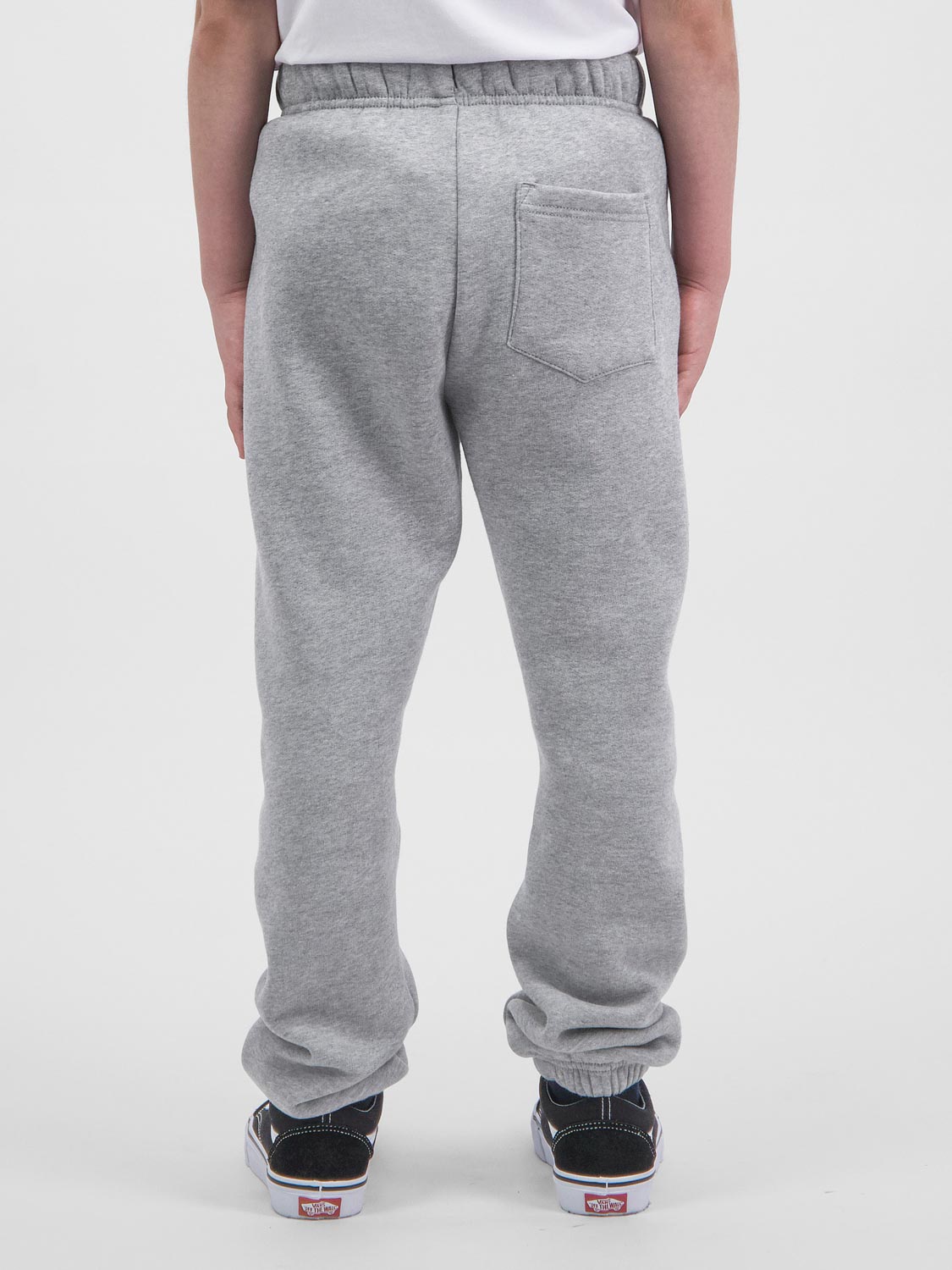 Rear view of a child wearing grey fleece track pants with an elastic waist and cuffed ankles.