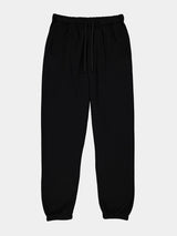 Womens black basis track pants with an elastic drawstring waistband and cuffed ankles.