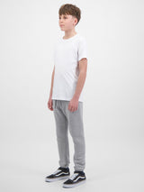 A youth model wears grey fleece track pants with an elastic drawstring waist and cuffed ankles.