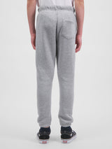 Rear view of a person wearing grey youth track pants with an elastic waist and cuffed ankles.