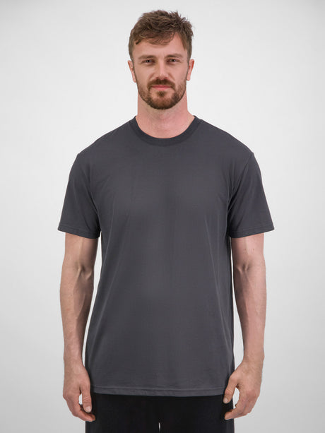 A man wearing a charcoal grey short sleeve crew neck cotton t-shirt with a relaxed fit.