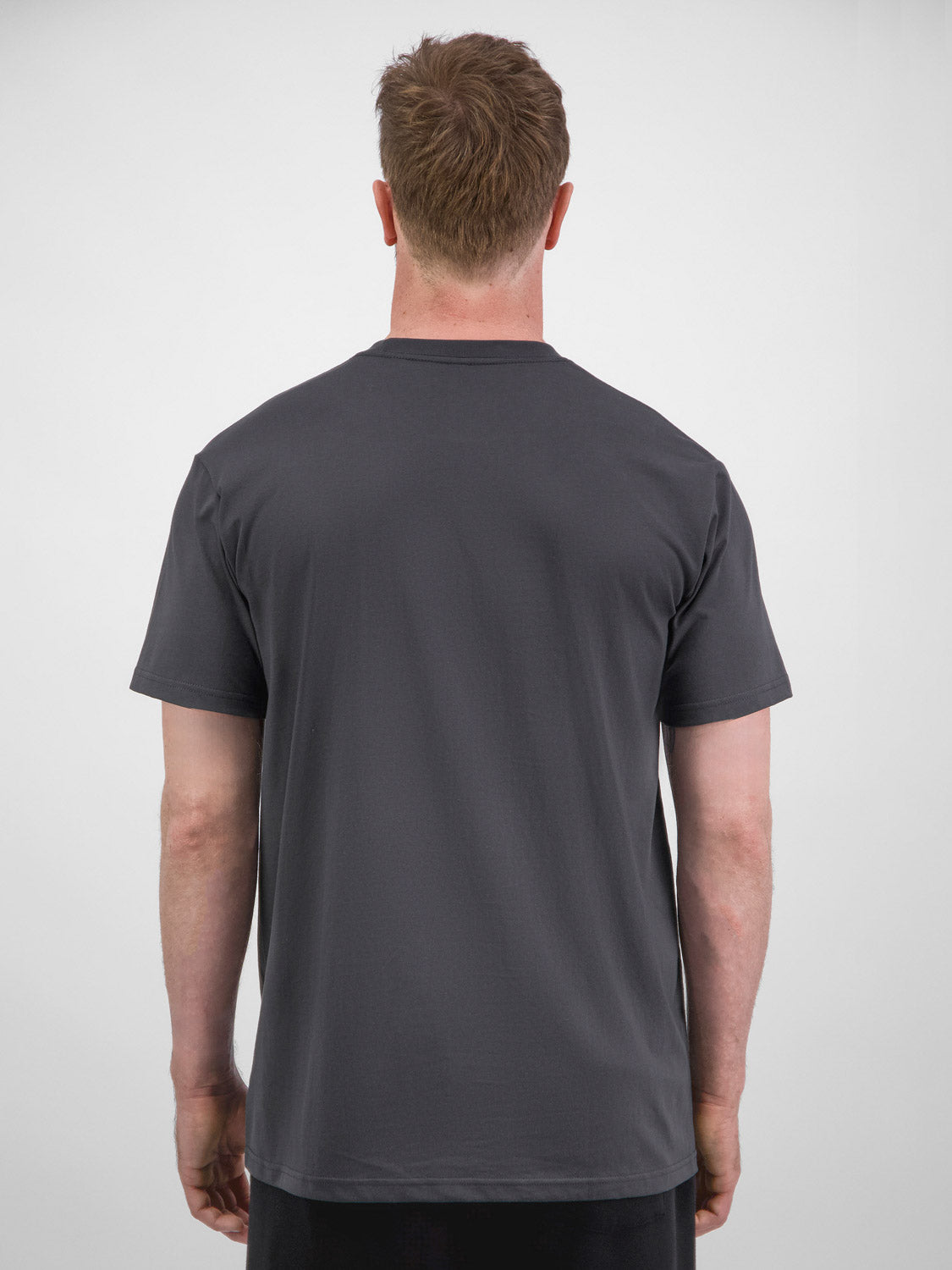 Rear view of a man wearing a charcoal grey short sleeve cotton t-shirt with a relaxed fit.