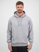 A man wearing a classic grey heathered hoodie with a front kangaroo pocket and ribbed cuffs.