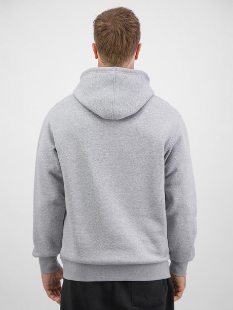 Rear view of a man wearing a grey heavy-weight hoodie with ribbed cuffs and waistband.