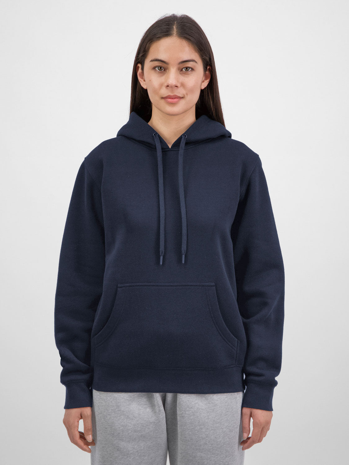 A woman wearing a navy blue mid-weight hoodie with a front pocket and matching drawstrings.