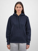 A woman wearing a navy blue mid-weight hoodie with a front pocket and matching drawstrings.