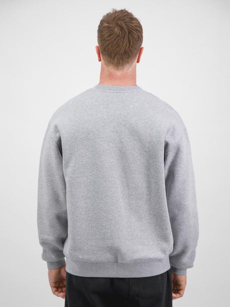 Rear view of a man wearing a grey crew neck sweatshirt with ribbed cuffs and waistband.